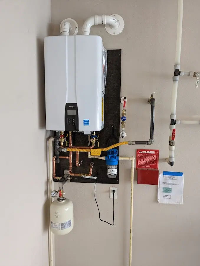 Professional plumber installing copper piping in a Lillington home